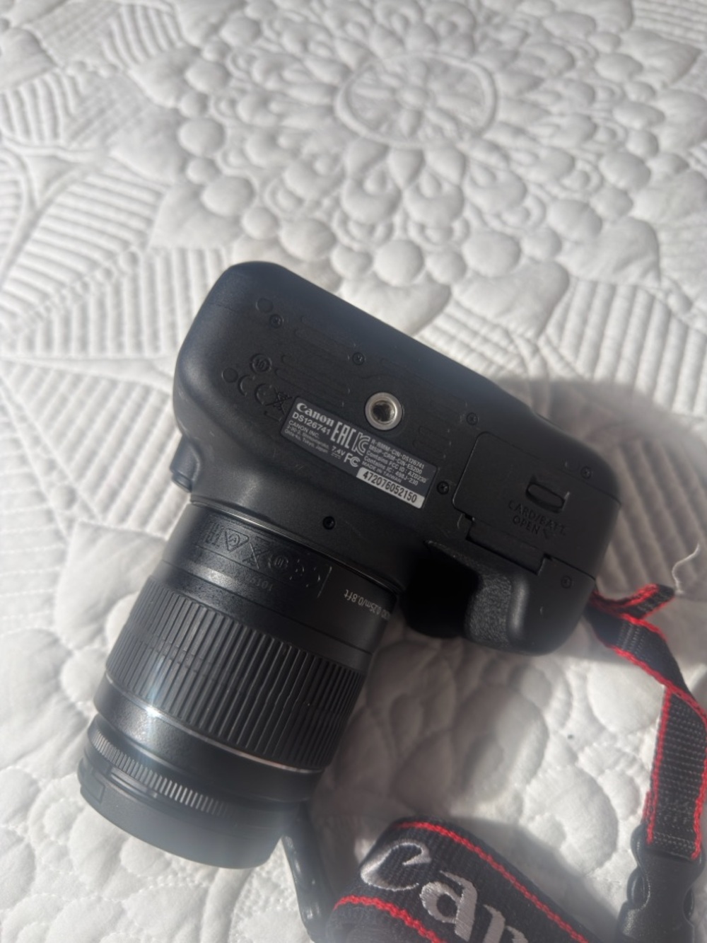 Canon Black DSLR Camera with Zoom Lens and Red-Trim Strap